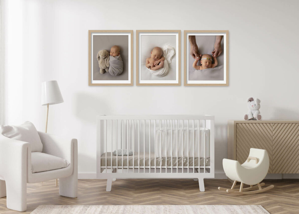 newborn baby boy photos hung up in nursery