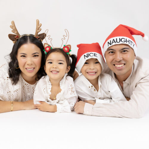family christmas photo with santa hat and rudolph ears