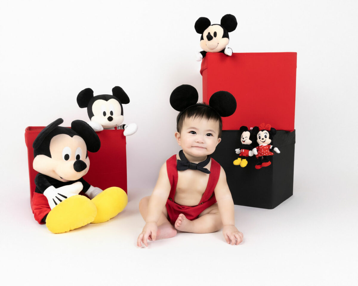 baby in mickey mouse ears and mickey mouse set up photography