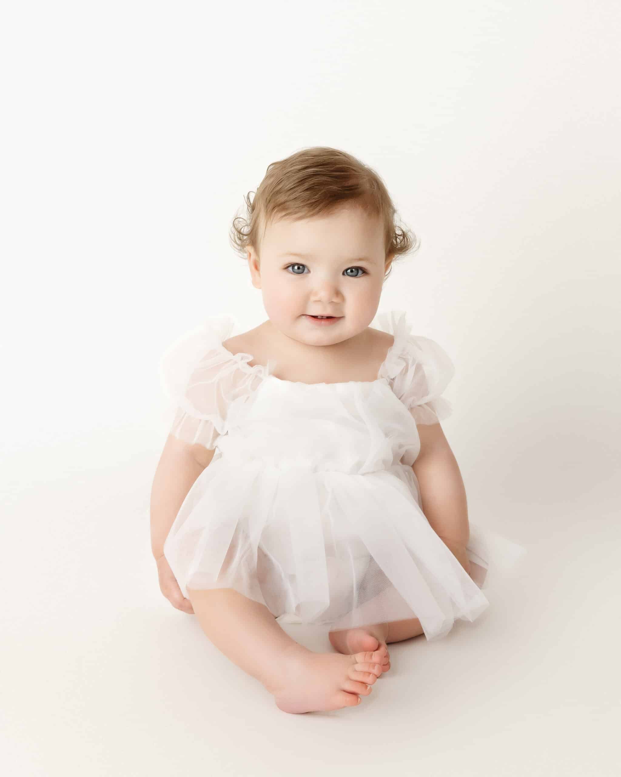 baby in white dress