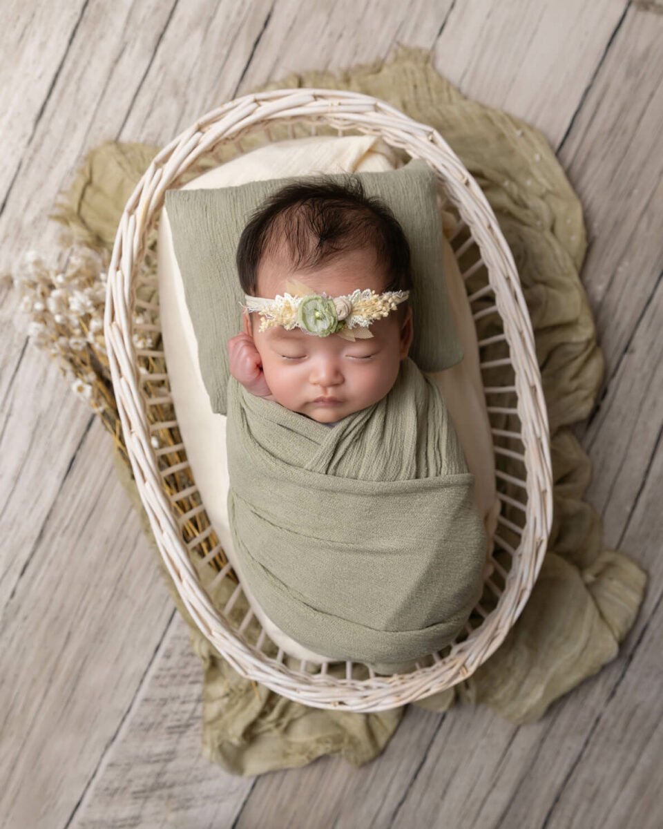 newborn girl in white basket