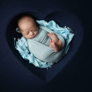 newborn baby in blue heart