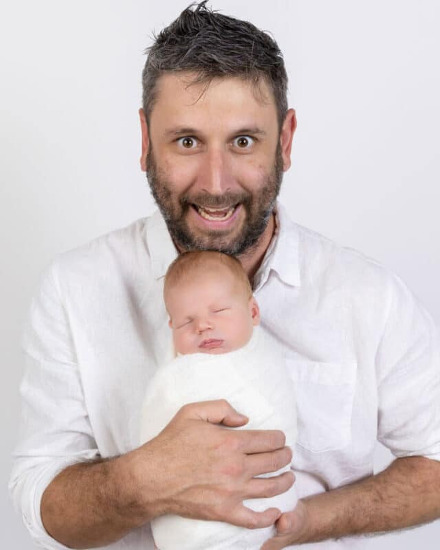 dad with newborn baby in white photography