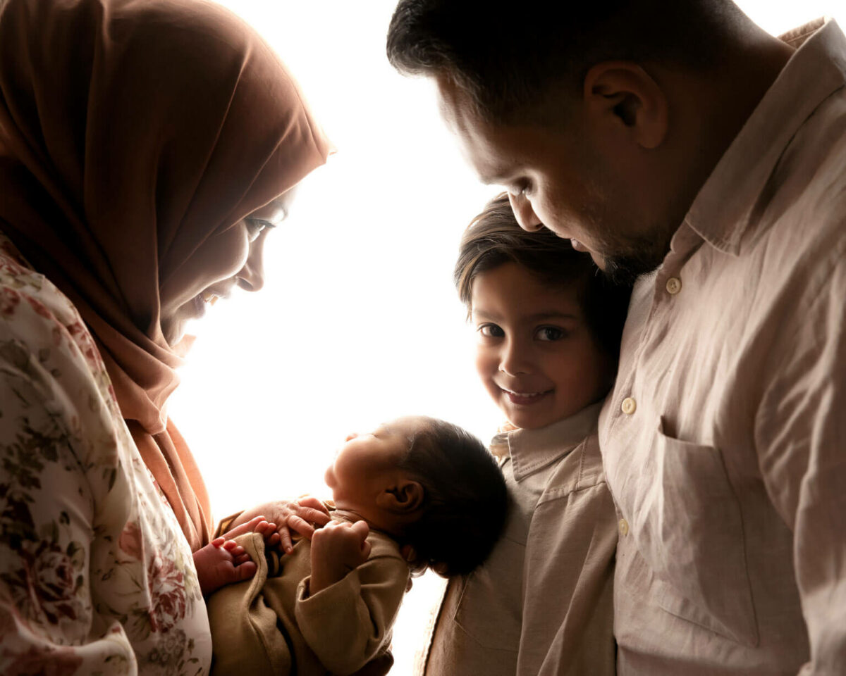 family holding baby photography