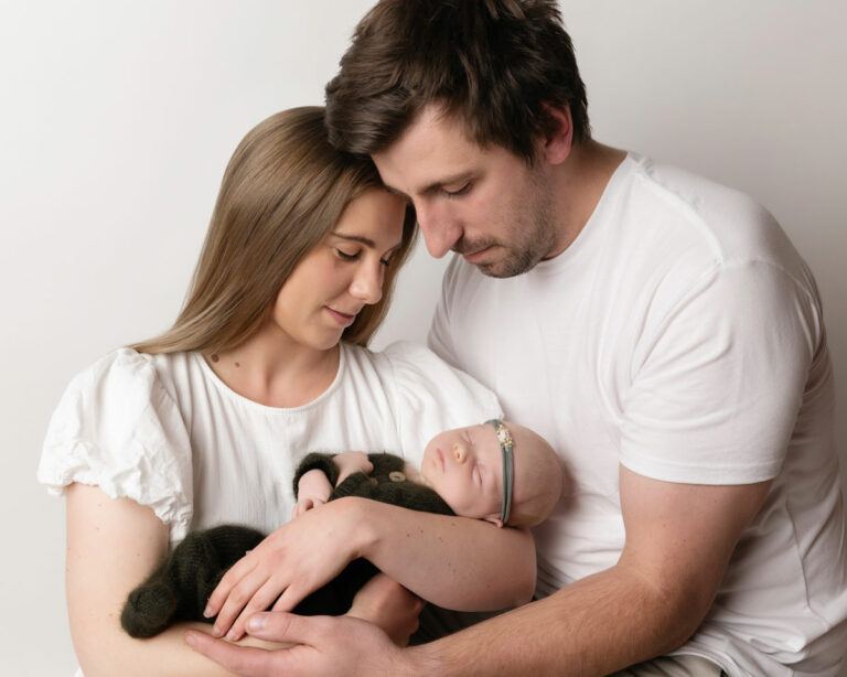 Family photo with newborn in green