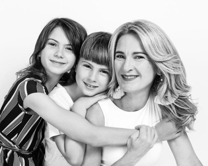 kids hugging mum and smiling black and white photography