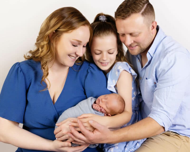 family in blue with newborn baby photography